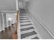 View of staircase with gray steps and white railing at 1235 Park Pass Way, Suwanee, GA 30024