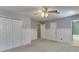 Spacious carpeted bedroom with doors, wainscoting, and bright windows at 2011 Two Springs Way, Lawrenceville, GA 30043