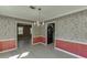 Stylish dining area featuring patterned wallpaper and an elegant chandelier at 2011 Two Springs Way, Lawrenceville, GA 30043