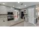 Spacious kitchen with stainless steel appliances, granite countertops, breakfast bar, and custom cabinets at 2011 Two Springs Way, Lawrenceville, GA 30043