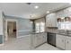 Bright kitchen with stainless steel appliances, granite counters, white cabinets, and view to an additional room at 2011 Two Springs Way, Lawrenceville, GA 30043