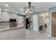 Eat-in kitchen with stainless steel appliances, granite countertops, white cabinets, and hardwood flooring at 2011 Two Springs Way, Lawrenceville, GA 30043