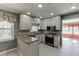 Traditional kitchen with granite countertops, mosaic tile backsplash, and modern stainless steel appliances at 2011 Two Springs Way, Lawrenceville, GA 30043