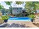 A beautiful in-ground pool and deck with blue seating, perfect for outdoor entertaining at 2011 Two Springs Way, Lawrenceville, GA 30043