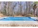 A large, inviting swimming pool surrounded by a wooden fence and mature trees at 2011 Two Springs Way, Lawrenceville, GA 30043