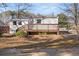 View of the back of a home with a wooden deck and natural surrounding landscape at 248 N Lake Dr, Jonesboro, GA 30236