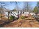 Rear view of a house with a deck and stairs surrounded by a tree covered backyard at 248 N Lake Dr, Jonesboro, GA 30236