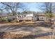 Backyard view featuring a wooden deck and ample space, with trees and some greenery at 248 N Lake Dr, Jonesboro, GA 30236