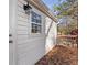 Exterior corner view of a home with white siding and a small wooden deck at 248 N Lake Dr, Jonesboro, GA 30236