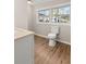 Bright bathroom featuring wood floors and a clear backyard view at 248 N Lake Dr, Jonesboro, GA 30236