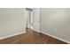 This bedroom has light gray walls and hardwood flooring that leads to an open door at 248 N Lake Dr, Jonesboro, GA 30236