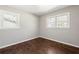 This bedroom features hardwood floors, neutral paint and updated windows at 248 N Lake Dr, Jonesboro, GA 30236