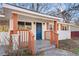 Inviting front porch with a blue front door, white brick, and brown pillars at 248 N Lake Dr, Jonesboro, GA 30236