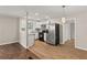 Kitchen with stainless steel appliances, white cabinetry, granite countertops, and hardwood floors at 248 N Lake Dr, Jonesboro, GA 30236