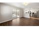 Living room featuring hardwood floors, sliding glass doors to the porch, and an open view to the kitchen at 248 N Lake Dr, Jonesboro, GA 30236