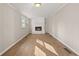 Living room featuring light hardwood floors and a fireplace with a painted white brick facade at 248 N Lake Dr, Jonesboro, GA 30236