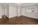 Living room featuring hardwood floors, white trim, and a window view of the neighborhood at 248 N Lake Dr, Jonesboro, GA 30236