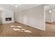 Living room with light hardwood floors and a fireplace with a painted white brick facade at 248 N Lake Dr, Jonesboro, GA 30236