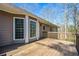 View of back deck with wood flooring, showing the exterior of the house with many windows at 2704 Loring Nw Rd, Kennesaw, GA 30152