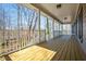 View of the spacious, covered porch overlooking a wooded backyard at 2704 Loring Nw Rd, Kennesaw, GA 30152