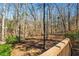 Multi-tiered backyard featuring a deck, trees, and a lower tier with mature trees at 2704 Loring Nw Rd, Kennesaw, GA 30152