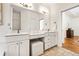 Bright bathroom with double sink vanity with quartz countertop, tile floor, and natural light at 2704 Loring Nw Rd, Kennesaw, GA 30152