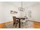 Traditional dining room features hardwood floors, a modern chandelier, and a window with natural light at 2704 Loring Nw Rd, Kennesaw, GA 30152