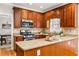 Gourmet kitchen featuring wood cabinets, granite countertops, stainless steel appliances at 2704 Loring Nw Rd, Kennesaw, GA 30152