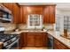 Well-equipped kitchen features a stainless steel stove, sink, and granite countertops at 2704 Loring Nw Rd, Kennesaw, GA 30152