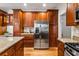 Open kitchen design with stainless steel refrigerator and granite countertops at 2704 Loring Nw Rd, Kennesaw, GA 30152