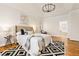 Staged main bedroom featuring a tray ceiling, hardwood floors, neutral colors, and an ensuite bathroom at 2704 Loring Nw Rd, Kennesaw, GA 30152