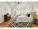 Bright main bedroom featuring a large window, hardwood floors, tray ceilings and neutral decor at 2704 Loring Nw Rd, Kennesaw, GA 30152