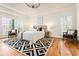 Beautiful main bedroom featuring a tray ceiling, hardwood floors, and a large window with natural light at 2704 Loring Nw Rd, Kennesaw, GA 30152