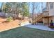 Backyard featuring a large patio area and wooden stairs leading to an upper deck at 4679 Newell Dr, Marietta, GA 30062