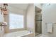 Bathroom featuring a soaking tub and glass-enclosed shower at 4679 Newell Dr, Marietta, GA 30062