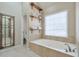 Bright bathroom features a soaking tub beneath a large window at 4679 Newell Dr, Marietta, GA 30062