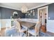 Elegant dining room with a stylish chandelier, dark accent wall, and hardwood floors at 4679 Newell Dr, Marietta, GA 30062