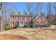 Classic brick home featuring symmetrical design, black shutters, and a well-manicured lawn at 4679 Newell Dr, Marietta, GA 30062