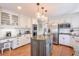 This open kitchen features an island, stainless steel appliances, and white cabinets at 4679 Newell Dr, Marietta, GA 30062