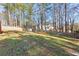 Large backyard with grass, trees, and a fence surrounding the property at 569 Alexander Farms Sw Vw, Marietta, GA 30064