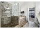 Bright bathroom featuring a glass shower, soaking tub, pebble-stone flooring, and a transom window at 569 Alexander Farms Sw Vw, Marietta, GA 30064