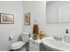 Bright half-bathroom with a modern sink, white vanity, and decorative artwork at 569 Alexander Farms Sw Vw, Marietta, GA 30064