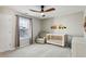 Bedroom featuring a crib, comfortable armchair, neutral walls and ceiling fan at 569 Alexander Farms Sw Vw, Marietta, GA 30064