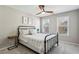 Cozy bedroom featuring a wrought iron bed frame, neutral walls, and a modern ceiling fan at 569 Alexander Farms Sw Vw, Marietta, GA 30064