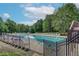 Sparkling community pool with plenty of lounge chairs and trees nearby at 569 Alexander Farms Sw Vw, Marietta, GA 30064