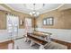 Cozy dining room features paneled walls, hardwood flooring, a chandelier, and ample natural light at 569 Alexander Farms Sw Vw, Marietta, GA 30064