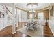 Bright dining room featuring elegant pillars, hardwood floors, modern chandelier, and staircase at 569 Alexander Farms Sw Vw, Marietta, GA 30064