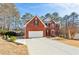 Beautiful two-story brick home featuring an attached garage and a spacious driveway on a sunny day at 569 Alexander Farms Sw Vw, Marietta, GA 30064