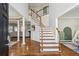 Elegant foyer featuring hardwood floors, a staircase with white risers, and a view into the living area at 569 Alexander Farms Sw Vw, Marietta, GA 30064