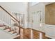 Grand foyer with hardwood floors, a staircase, a white front door with glass, and natural light at 569 Alexander Farms Sw Vw, Marietta, GA 30064